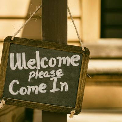 A chalk sign that says "Welcome; Please Come In" / Photo Credit: Unsplash 